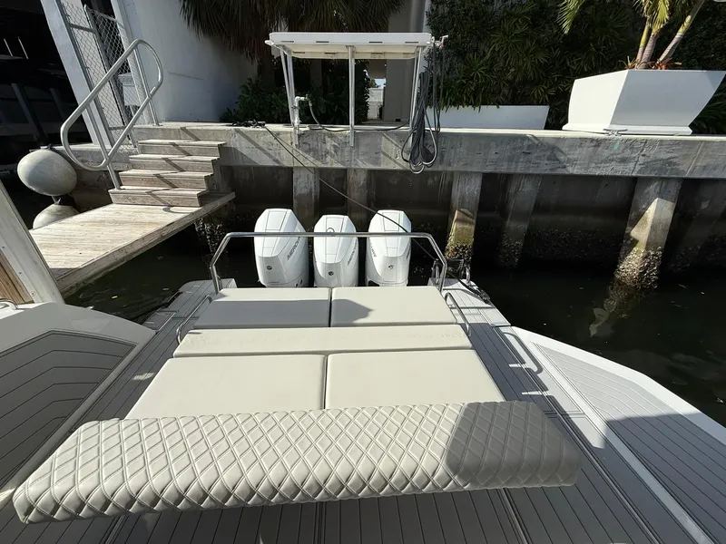 Slide: The Image of 2025 Schaefer 375 boat with triple outboard engines docked at a marina. - 29