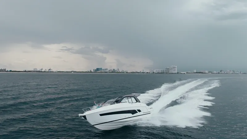 Slide: The Image of Schaefer 375 yacht cruising on open water under cloudy skies, 2025 model. - 3