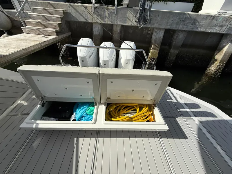 Slide: The Image of Open storage compartments on a 2025 Schaefer 375 boat, with visible equipment and supplies. - 31