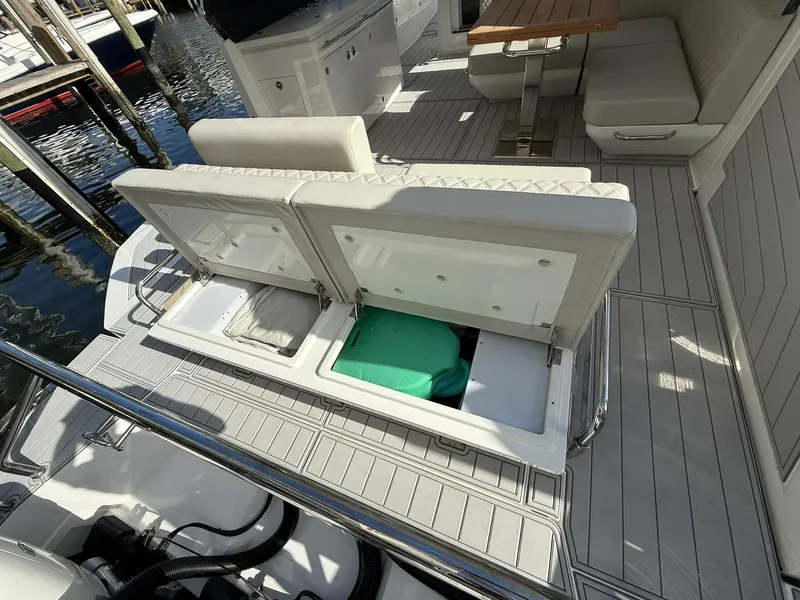 Slide: The Image of 2025 Schaefer 375 yacht interior with open storage compartments and seating area. - 32