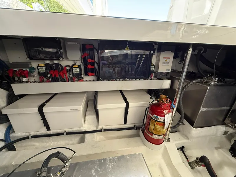 Slide: The Image of Engine compartment of 2025 Schaefer 375 boat with fire extinguisher and electrical components. - 38