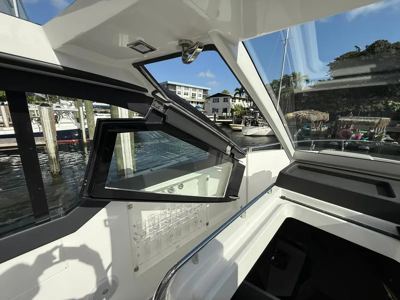Slide: The Image of Interior view of 2025 Schaefer 375 yacht with open window, dockside scenery. - 39
