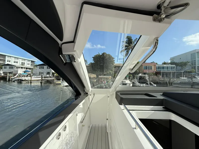 Slide: The Image of Interior view of 2025 Schaefer 375 yacht docked by waterfront homes. - 41