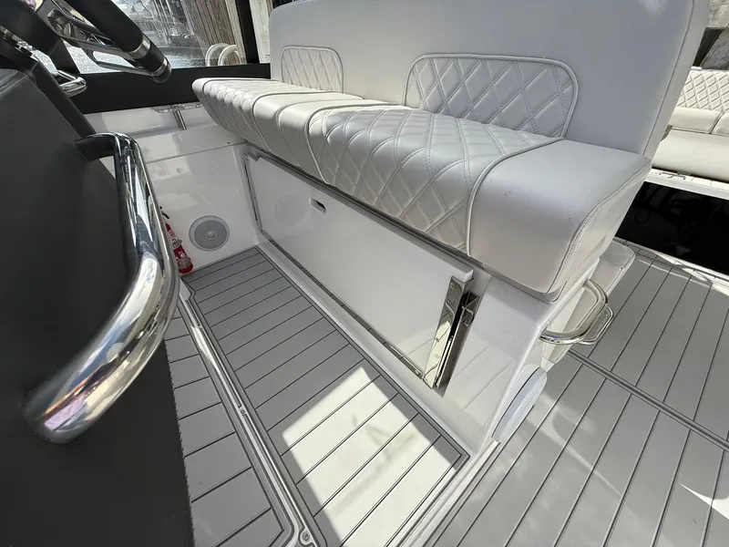 Slide: The Image of Luxurious interior of 2025 Schaefer 375 boat with white quilted seating and sleek flooring. - 44