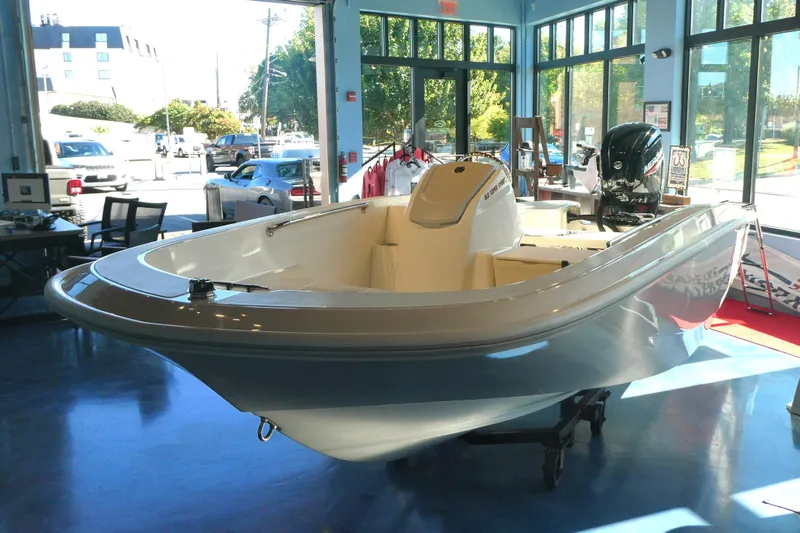 The Image of 2025 Boston Whaler 160 Super Sport boat displayed in a showroom with large windows. - 0