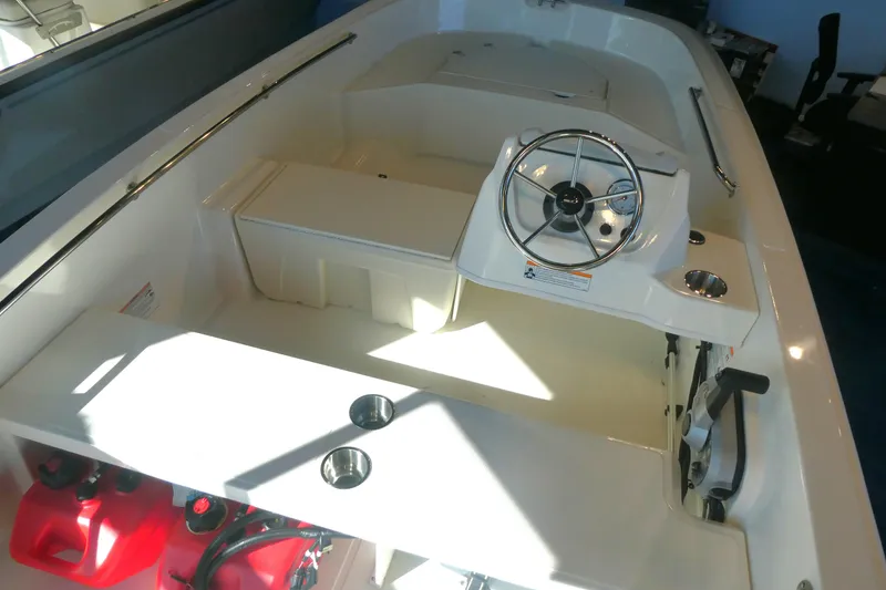 Slide: The Image of 2025 Boston Whaler 160 Super Sport interior with steering wheel and seating area. - 3