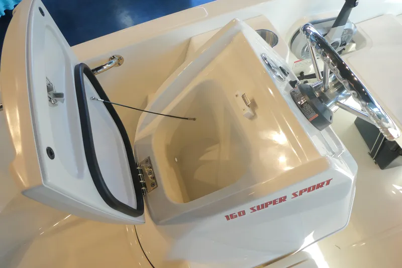 Slide: The Image of 2025 Boston Whaler 160 Super Sport boat console with open storage compartment. - 8