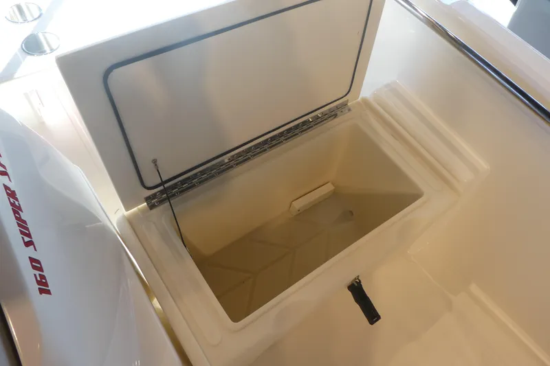 Slide: The Image of 2025 Boston Whaler 160 Super Sport boat storage compartment open, showcasing interior space. - 9