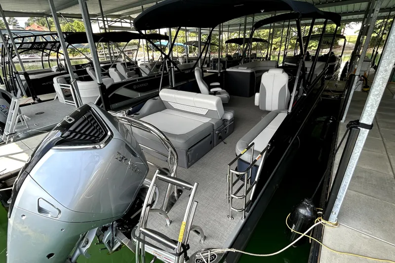 Slide: The Image of Outboard motor on 2025 Godfrey Monaco 255 DFL pontoon boat docked in water. - 11