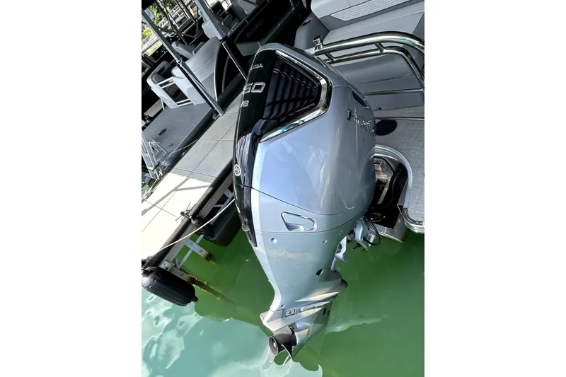 Slide: The Image of 2025 Godfrey Monaco 255 DFL boat interior with modern helm and comfortable captain's chair. - 12