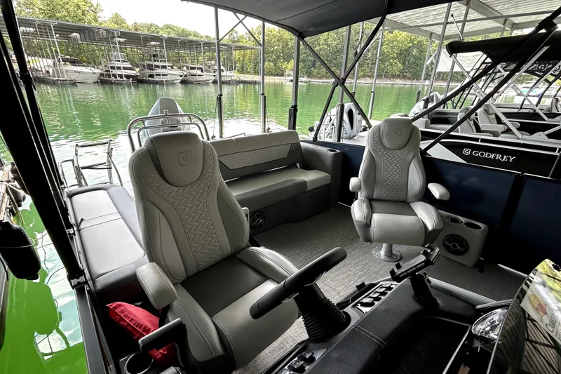 Slide: The Image of 2025 Godfrey Monaco 255 DFL boat interior with modern helm and luxurious seating. - 15