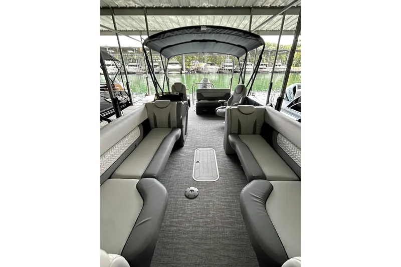 Slide: The Image of 2025 Godfrey Monaco 255 DFL pontoon boat docked, featuring spacious seating and modern design. - 7