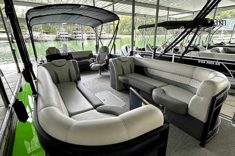 Slide: The Image of Interior of 2025 Godfrey Monaco 255 DFL pontoon boat with luxurious seating and helm. - 9