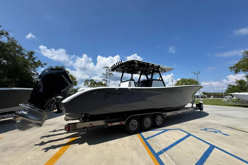 Slide: The Image of 2026 Yellowfin 39 Offshore boat on trailer under clear blue sky. - 11