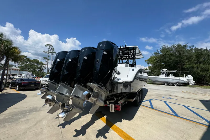 Slide: The Image of 2026 Yellowfin 39 Offshore boat with four powerful outboard engines in a sunny marina. - 13