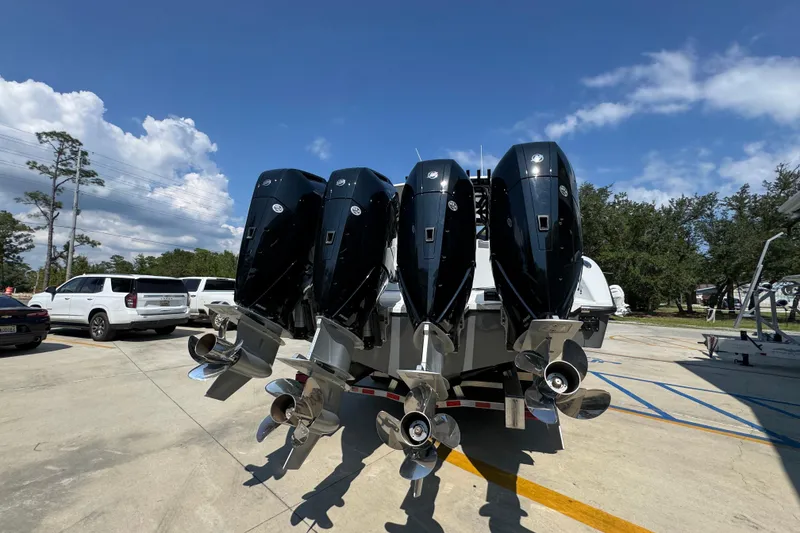 Slide: The Image of 2026 Yellowfin 39 Offshore boat with four powerful outboard engines in a parking lot. - 14