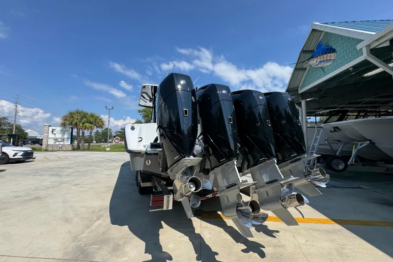 Slide: The Image of 2026 Yellowfin 39 Offshore boat with four powerful outboard engines at a marina. - 16