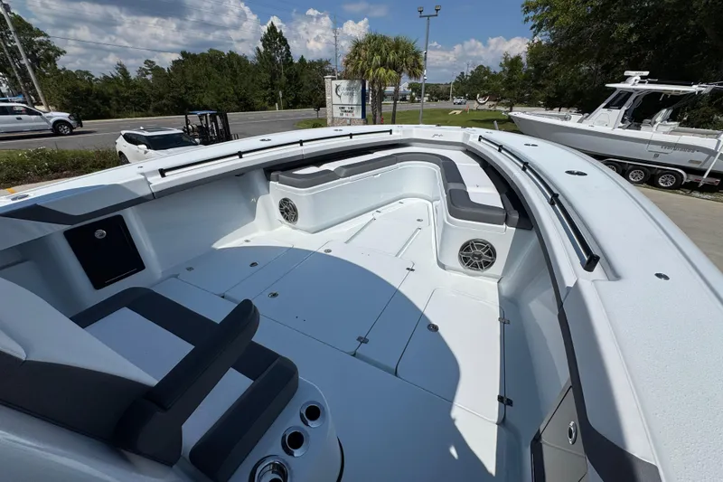 Slide: The Image of 2026 Yellowfin 39 Offshore boat interior with seating and speakers, parked outdoors. - 22