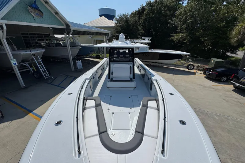 Slide: The Image of 2026 Yellowfin 39 Offshore boat at a marina, showcasing spacious deck and seating. - 26