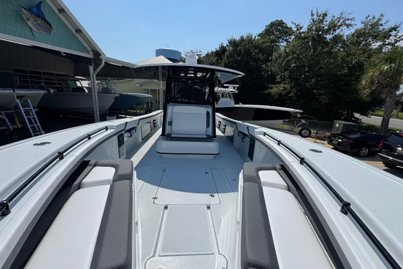 Slide: The Image of 2026 Yellowfin 39 Offshore boat with spacious deck and seating, docked outdoors. - 27