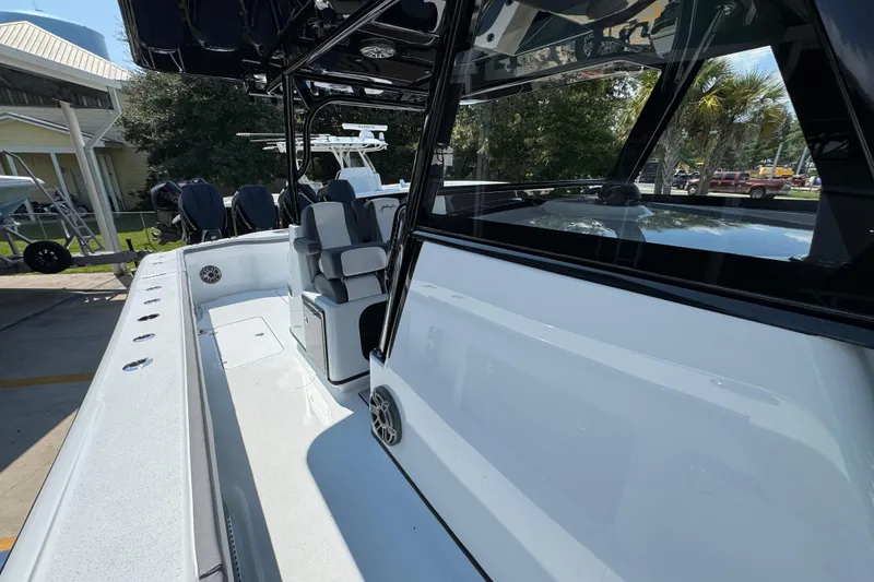 Slide: The Image of 2026 Yellowfin 39 Offshore boat interior with seating and console, docked outdoors. - 30
