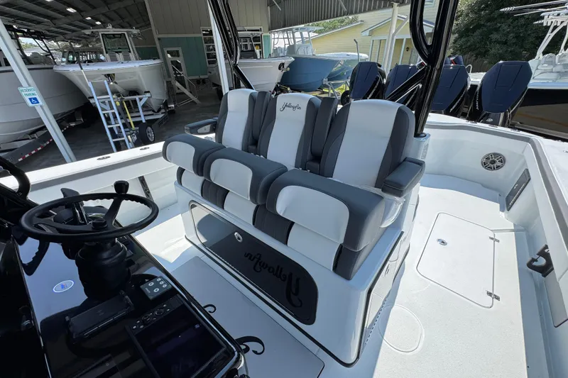 Slide: The Image of 2026 Yellowfin 39 Offshore boat interior with steering wheel and cushioned seating. - 31
