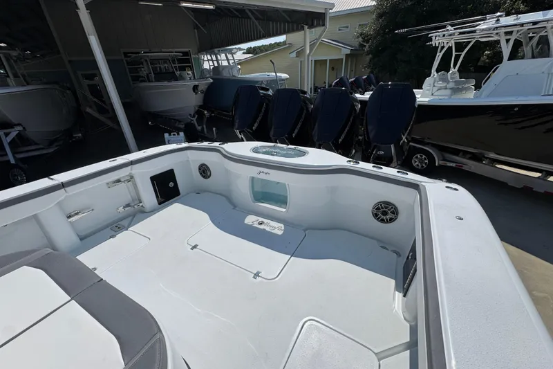 Slide: The Image of 2026 Yellowfin 39 Offshore boat interior with multiple outboard engines in a showroom. - 46
