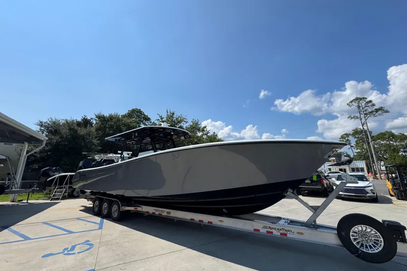 Slide: The Image of 2026 Yellowfin 39 Offshore boat on trailer under clear blue sky. - 8
