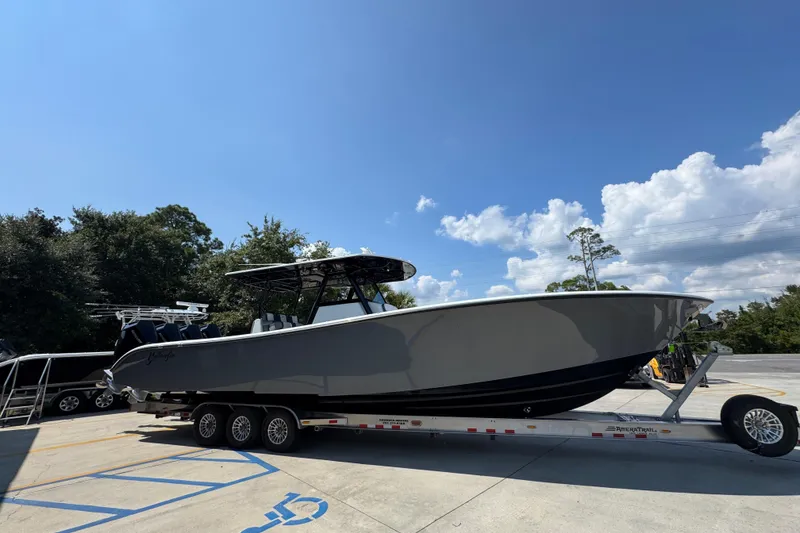 Slide: The Image of 2026 Yellowfin 39 Offshore boat on trailer under clear blue sky. - 9