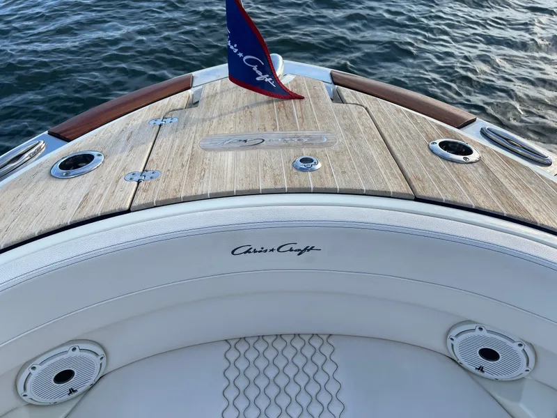 Slide: The Image of 2021 Chris-Craft 28 LAUNCH GT boat deck with wood finish and logo. - 10