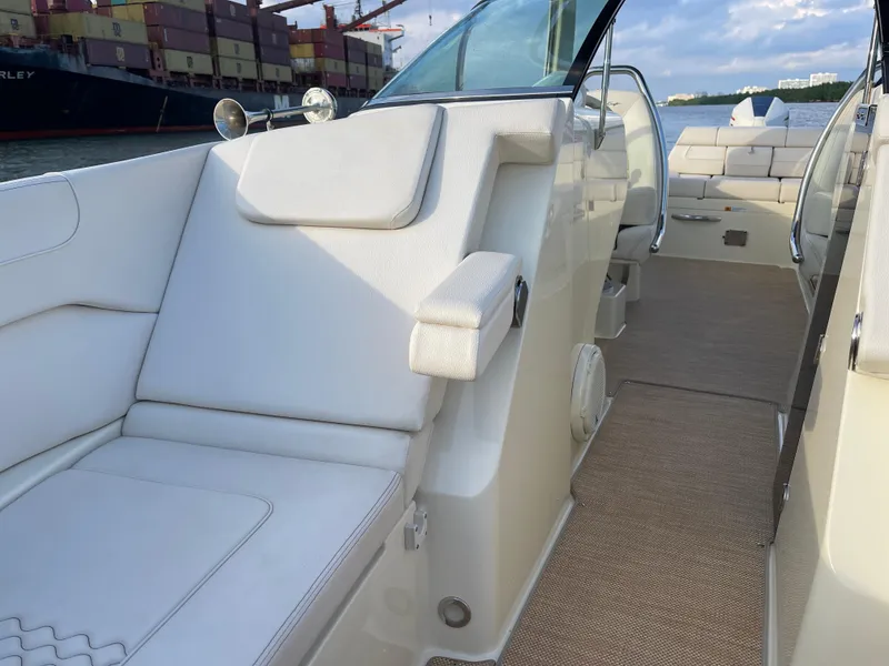 Slide: The Image of Interior of 2021 Chris-Craft 28 Launch GT boat with white seating and beige flooring. - 11