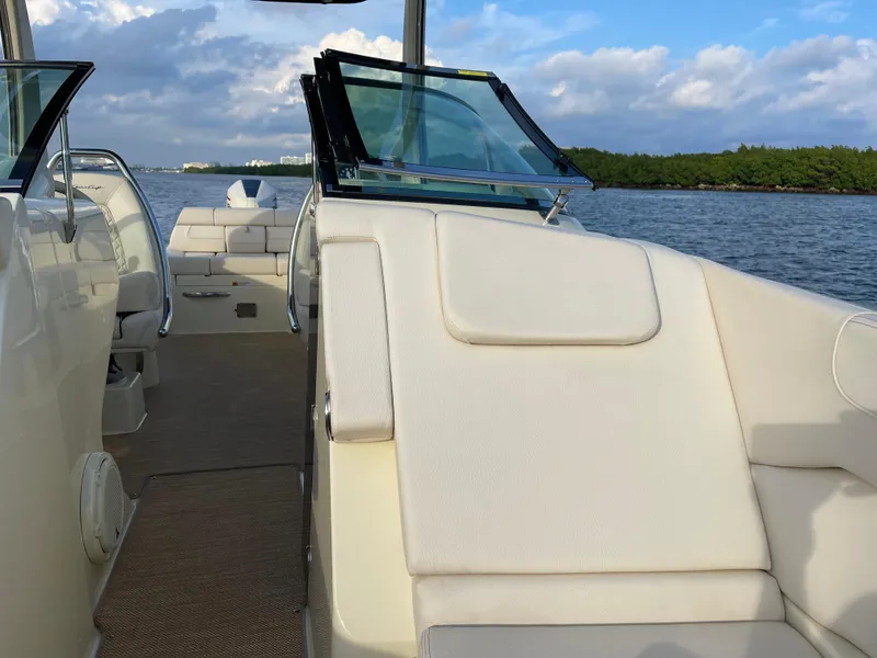 Slide: The Image of 2021 Chris-Craft 28 LAUNCH GT boat interior with luxurious seating on a scenic waterway. - 12