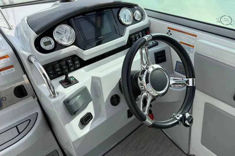 Slide: The Image of Cockpit of 2019 Regal 28 Express boat with modern steering and controls. - 17