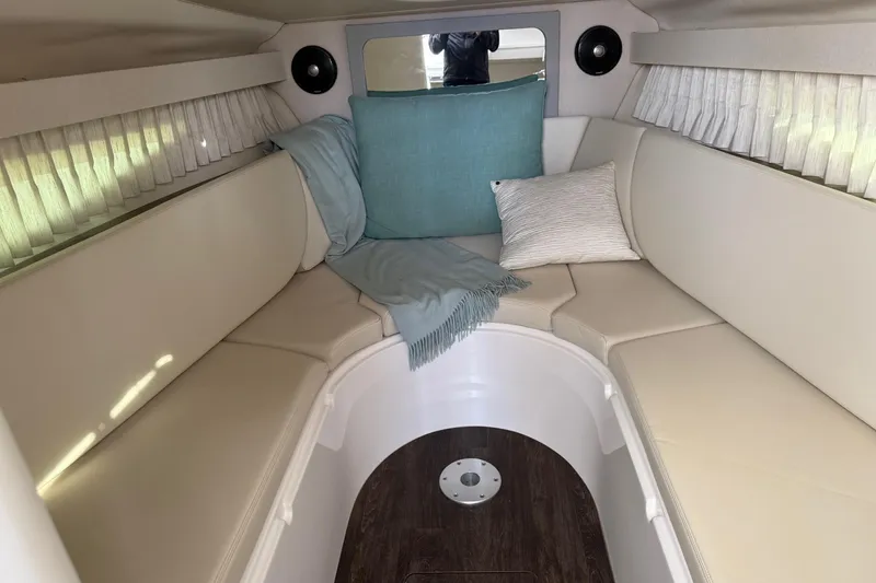Slide: The Image of Cozy interior of 2019 Regal 28 Express boat with cushions and curtains. - 19
