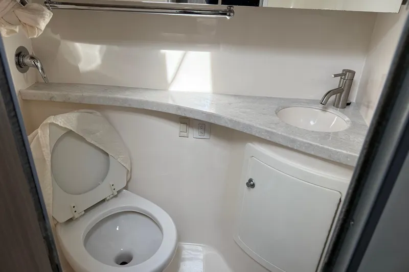 Slide: The Image of 2019 Regal 28 Express bathroom with toilet, sink, and countertop. - 23