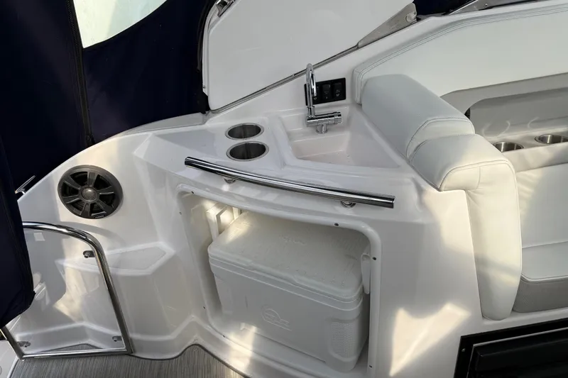 Slide: The Image of 2019 Regal 28 Express boat interior with sink, seating, and storage area. - 25