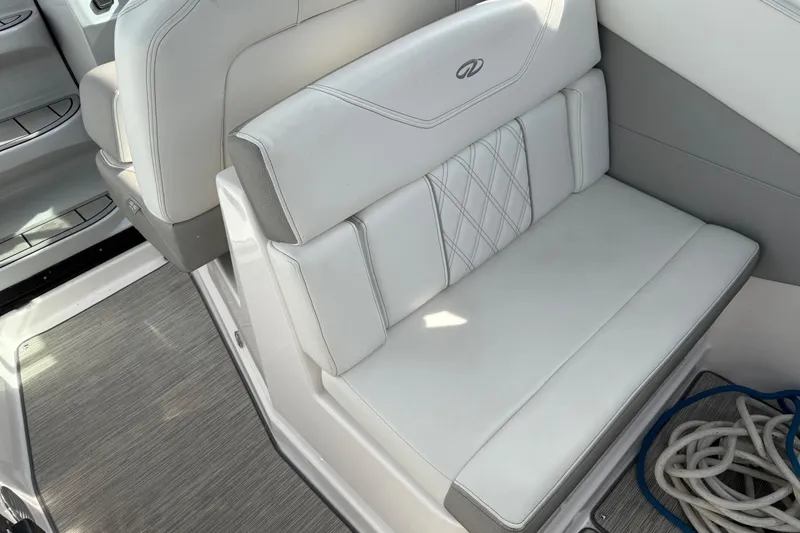 Slide: The Image of White leather seating on a 2019 Regal 28 Express boat interior. - 30