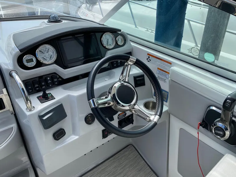 Slide: The Image of 2019 Regal 28 Express boat dashboard with steering wheel and control panel. - 4