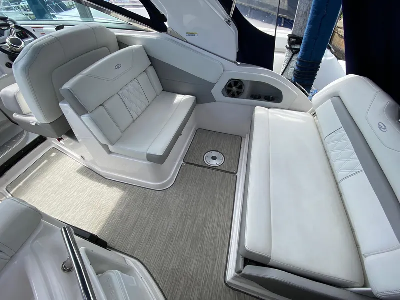 Slide: The Image of 2019 Regal 28 Express boat interior with white seating and modern design. - 8