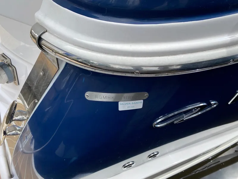Slide: The Image of 2019 Regal 28 Express boat, blue and white exterior with silver detailing. - 9