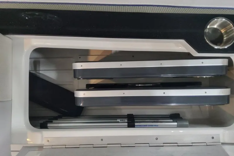 Slide: The Image of Storage compartment in 2026 Formula 310 Bowrider boat, featuring organized shelves and equipment. - 102