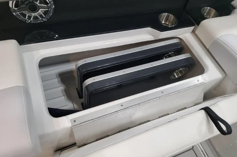 Slide: The Image of Storage compartment in 2026 Formula 310 Bowrider boat with cup holders and speaker. - 103