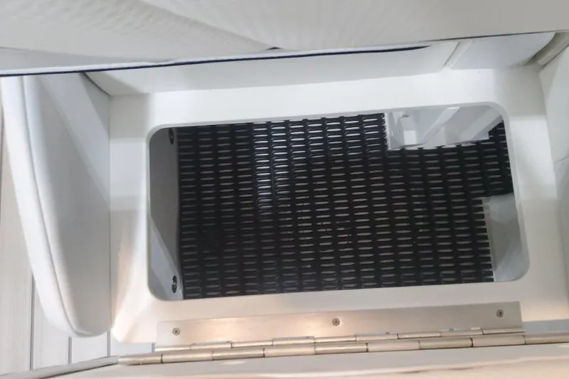 Slide: The Image of 2026 Formula 310 Bowrider storage compartment with black grid mat. - 104