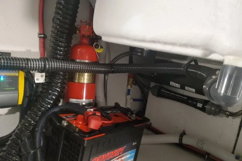 Slide: The Image of Engine compartment of 2026 Formula 310 Bowrider with battery and fire extinguisher. - 110