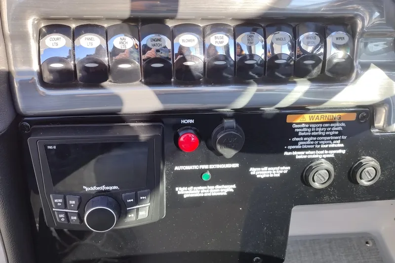 Slide: The Image of 2026 Formula 310 Bowrider boat with sleek white seating and cup holders. - 30