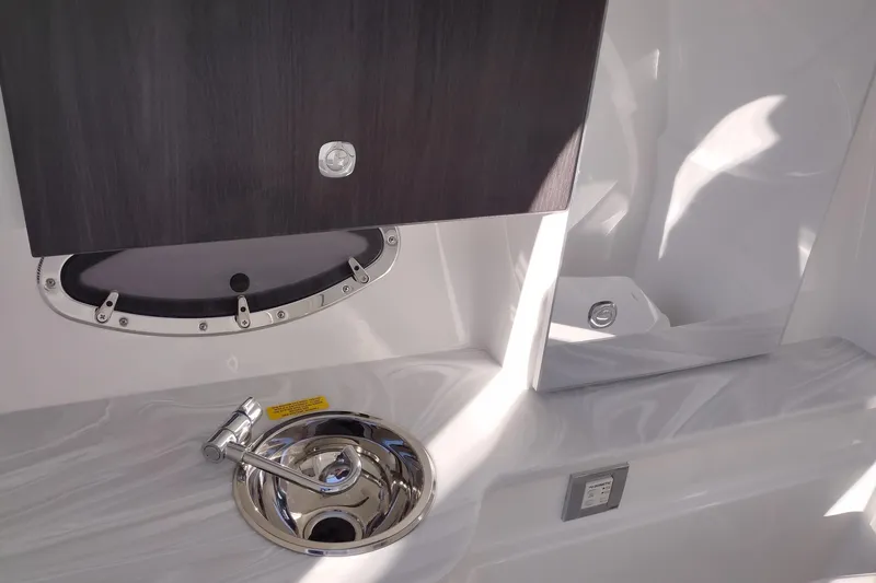 Slide: The Image of 2026 Formula 310 Bowrider boat in a warehouse, showcasing sleek design and modern features. - 37