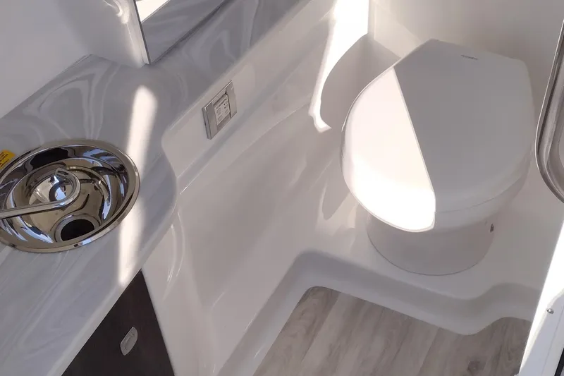 Slide: The Image of 2026 Formula 310 Bowrider boat with sleek blue and white design. - 38