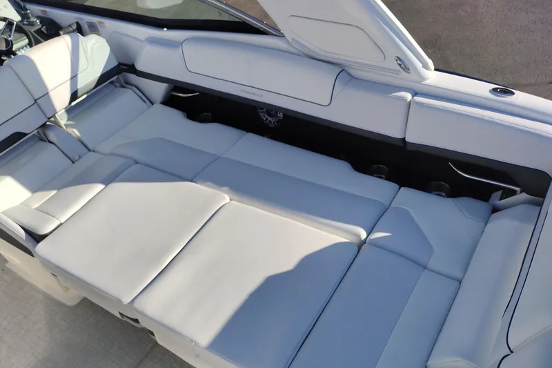 Slide: The Image of 2026 Formula 310 Bowrider interior with sleek seating and modern design in a showroom. - 55