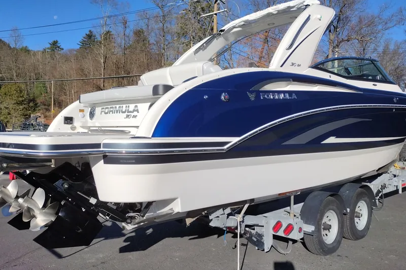 Slide: The Image of 2026 Formula 310 Bowrider boat on trailer, showcasing sleek design and powerful engines. - 6