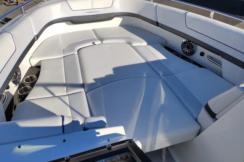 Slide: The Image of 2026 Formula 310 Bowrider storage compartment with white cushioned seating and black interior. - 67